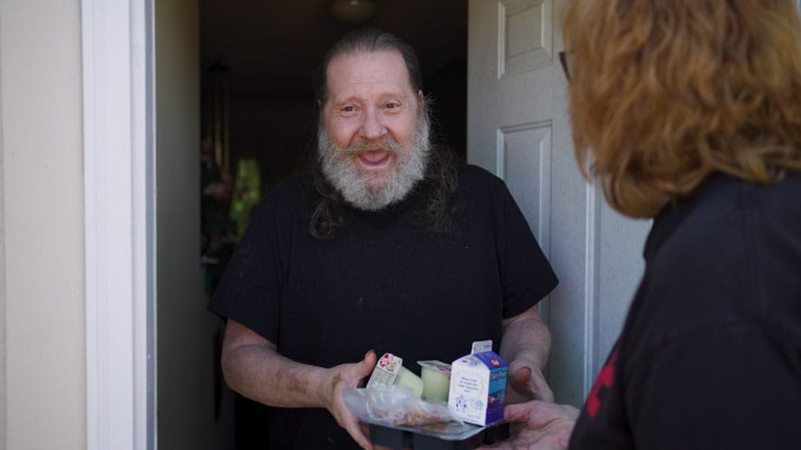 Ginny Williams delivering a meal