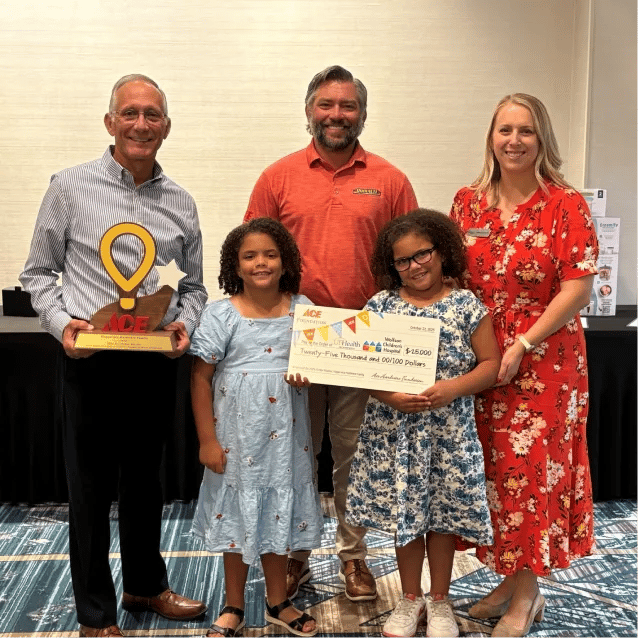 Bill and Jacob Hagan with their local hospital representative and patients