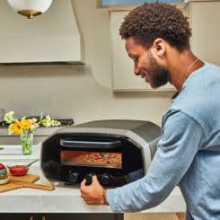 Man turning on Ooni volt oven