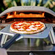 Taking pizza out of Ooni Koda 16 oven
