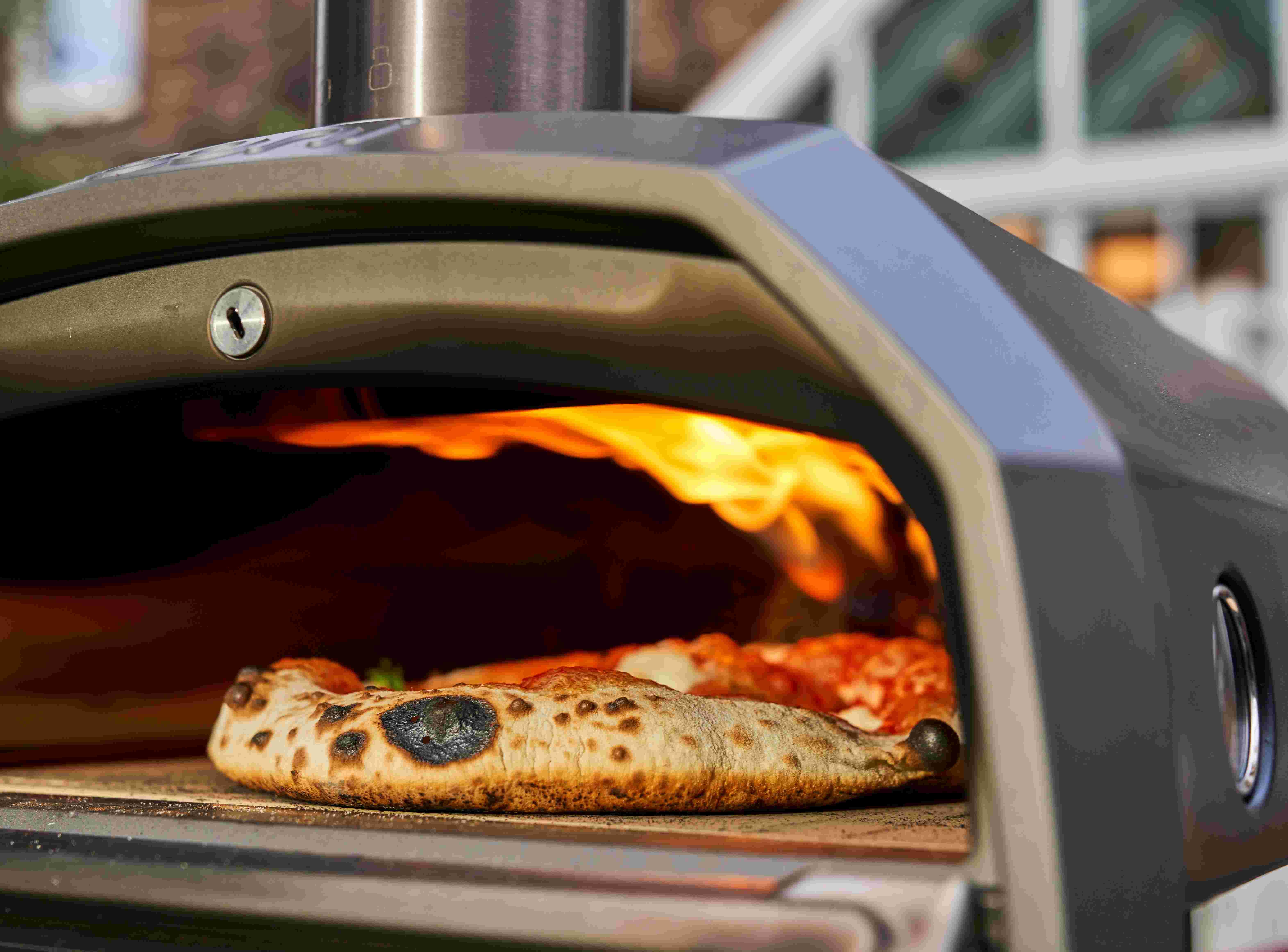 Pizza cooking inside Ooni Karu 2