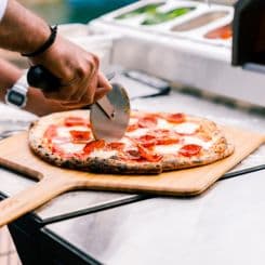 Cutting pizza on Ooni 16'' bamboo peel