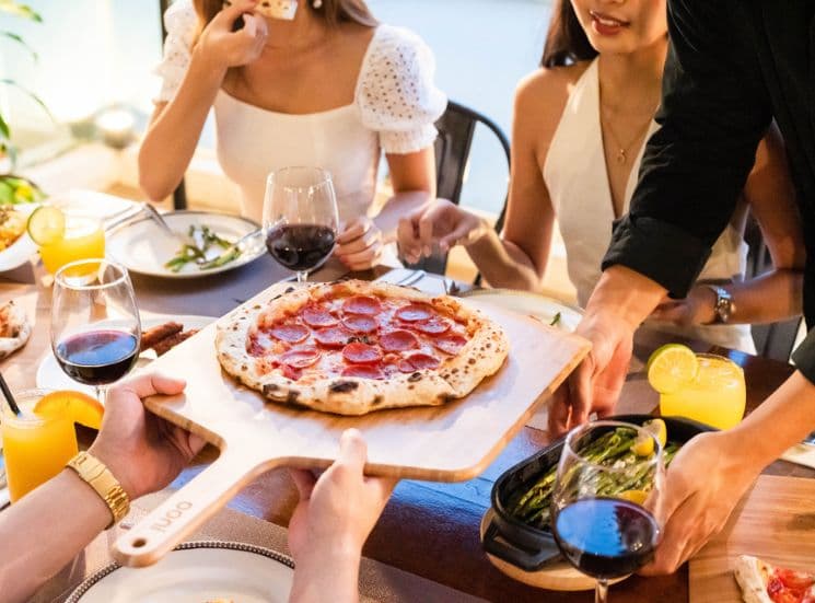 Serving pizza using Ooni 16'' bamboo peel