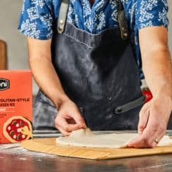 Man flatening Ooni's Neapolitan dough