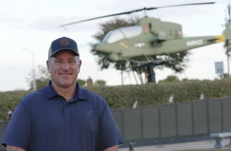 Man in front of helicopter