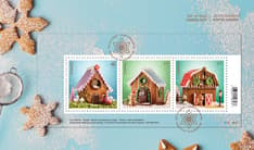 Blue background, cookies and sugar, collectible envelope with three-stamp souvenir sheet featuring gingerbread houses for birds, dogs and reindeer. 