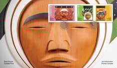 Front of envelope the side panel of the Bentwood Box that honours Inuit experiences at residential schools. Stamps top right corner with cancel mark.