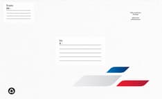 White envelope with &quot;To&quot; and &quot;From&quot; address fields, area for stamp, recycling symbol, and abstract red, white, and blue graphic.