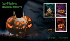 Front shows a pumpkin split open to reveal a glowing skull surrounded by fog and three stamps.