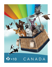 Stamp depicting baby animals flying in a hot air balloon on a blue sky with birds surrounding them and orcas jumping below. 