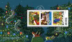 Envelope front depicts squirrels decorating a snowy forest with lights and ornaments as Fox and Rabbit watch and features three-stamp souvenir sheet.