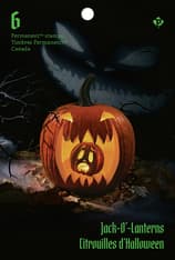 Glowing pumpkin on a dark background with eerie jack-o’-lantern shadow. Includes Jack-O’-Lanterns Permanent stamps and Canada text.