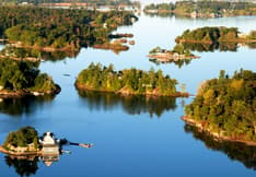 Aerial image of a grouping of islands in Thousand Islands National Park. Postage Paid mark upper right.