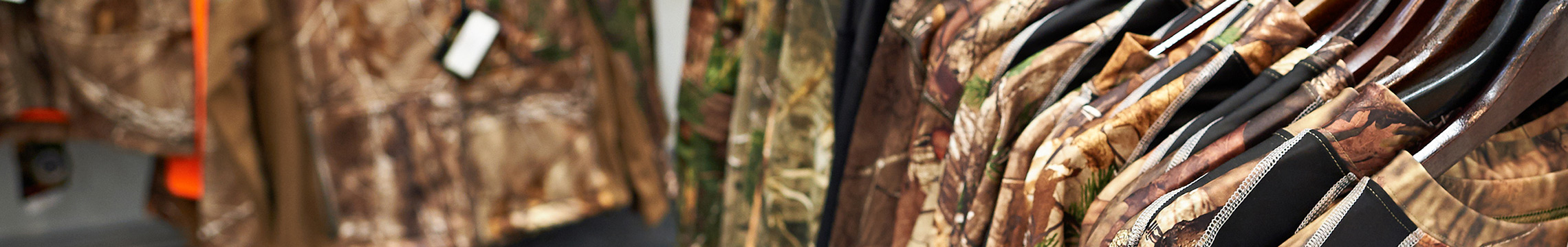 Camo hunting clothing hung up around a retail store