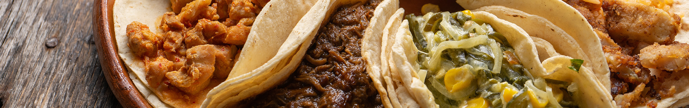 Plate of tacos with a variety of ingredients and toppings