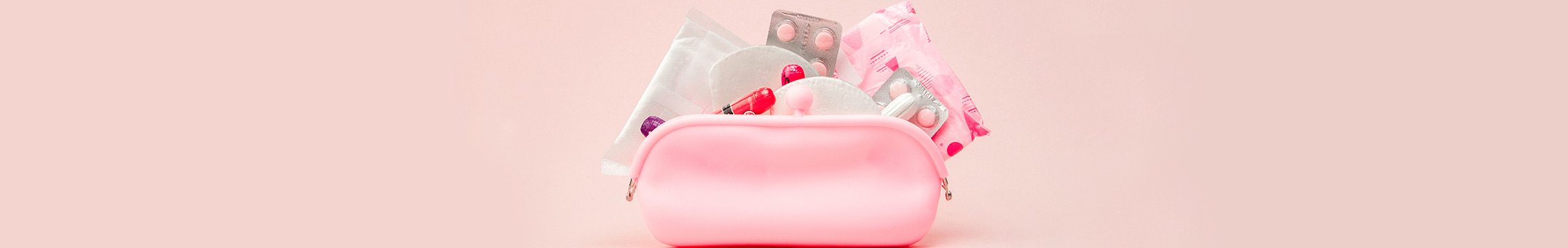 Pink makeup bag filled with feminine hygiene products and pain relievers