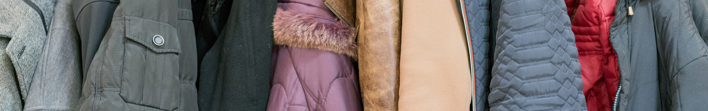 Variety of women's winter coats hung together on a rack