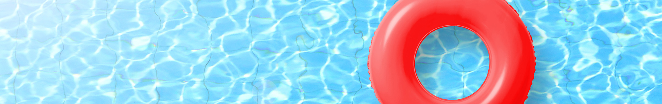 Red floatation donut sitting in a crystal clear pool