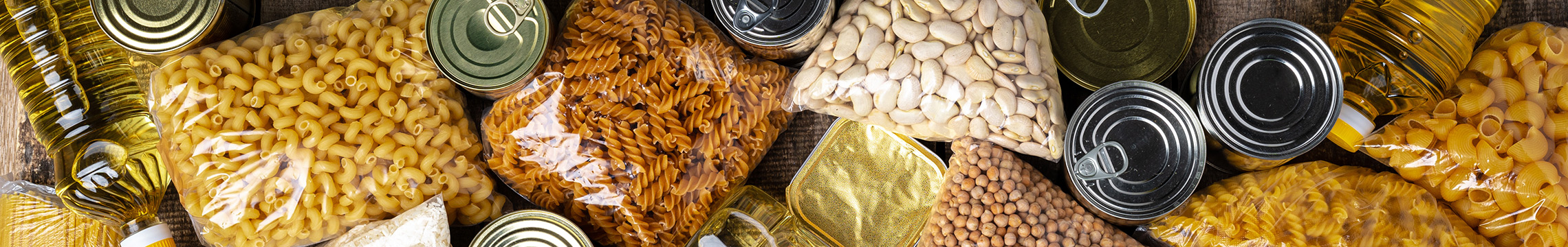Canned and dried pantry goods against a wood background