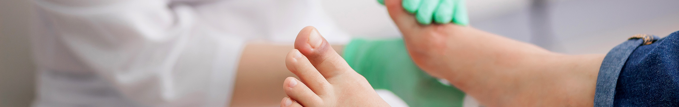 Doctor tenderly examining the foot of a patient with diabetes